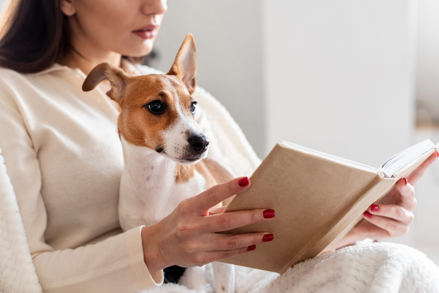 Side View Woman Reading While Holding Her Dog